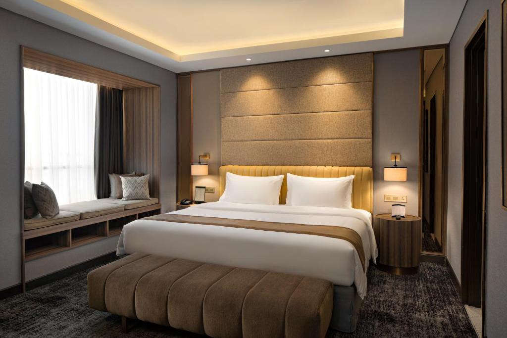 雅加达Sutasoma Hotel的一间设有大床和窗户的酒店客房