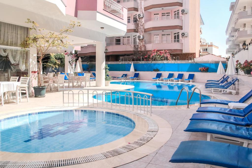阿拉尼亚Bella Rose Apart Hotel, Renovated in 2023!的一座大型游泳池,旁边是一座蓝色椅子