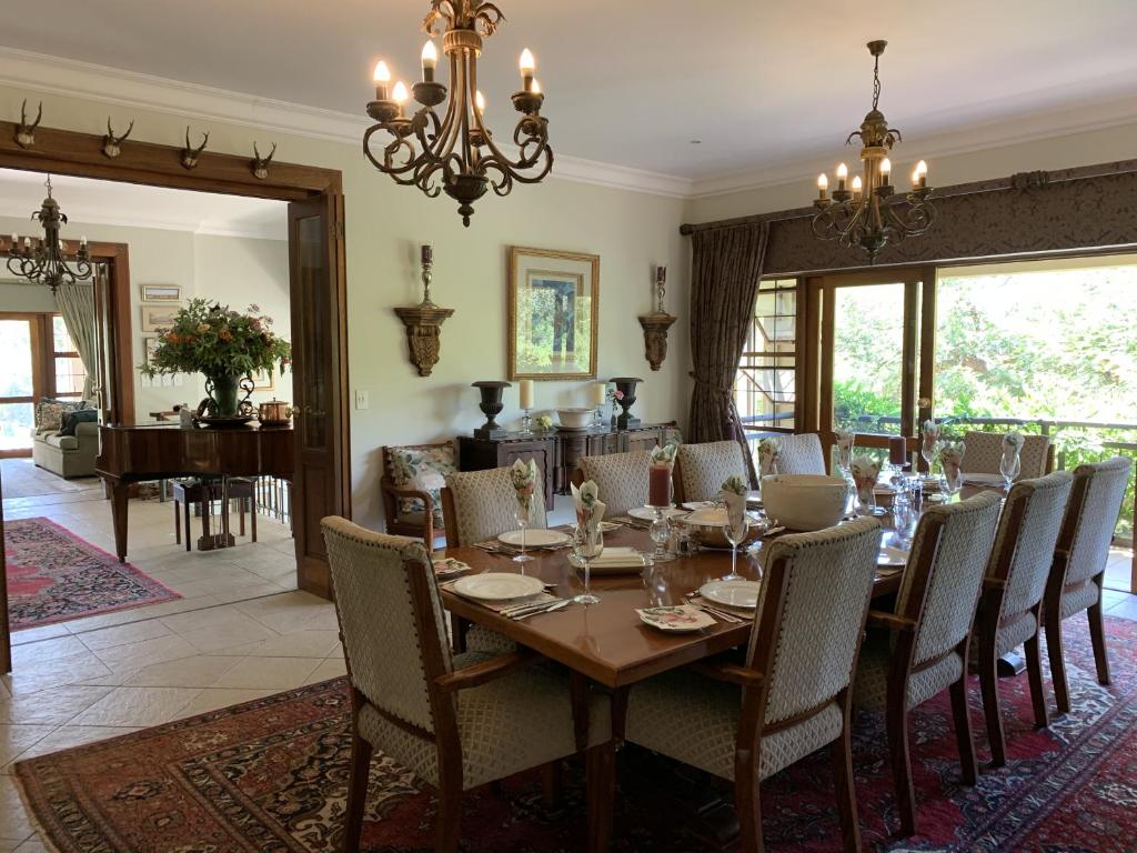 路易特里哈特Mountain Rose Guesthouse的一间带木桌和椅子的用餐室