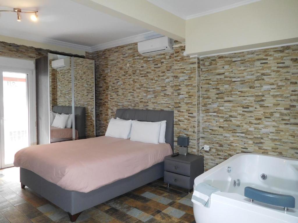 塞萨洛尼基Luxury Living Apartments and Spa的一间卧室配有一张床和浴缸