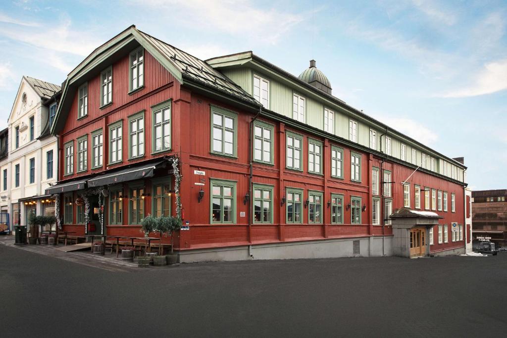 利勒哈默尔斯堪迪克维多利亚酒店的街道上一座红色的大建筑,窗户