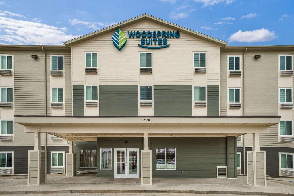 萨尔弗WoodSpring Suites Sulphur - Lake Charles的上面有摔跤俱乐部标志的建筑