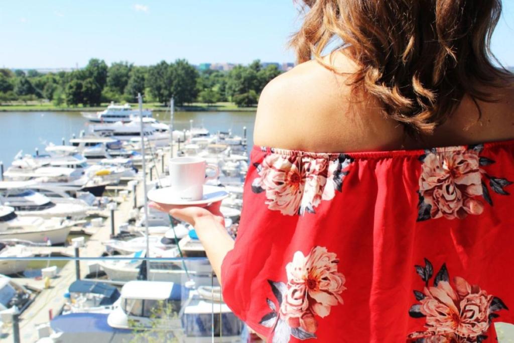 华盛顿InterContinental - Washington D.C. - The Wharf by IHG的站在码头前的有船的妇女