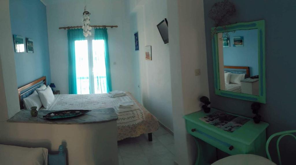 利普西岛Hotel Glaros Lipsi的小房间设有床和镜子
