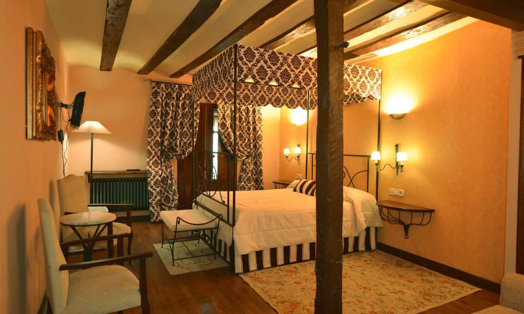 布里纳斯Casa Rural de Legarda的卧室配有一张床和一张桌子及椅子