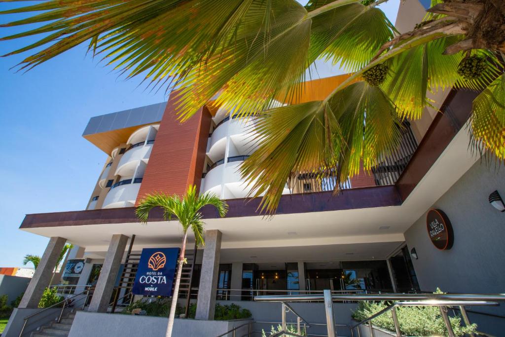 阿拉卡茹Hotel da Costa By Nobile的一座棕榈树建筑
