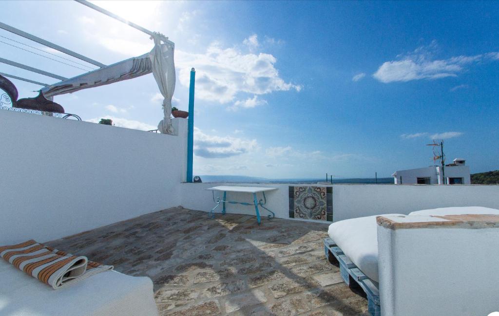 贝赫尔-德拉弗龙特拉CASA LA FUENTE C Casas Vejer Debra的阳台配有一张床铺和一张桌子,享有海景。