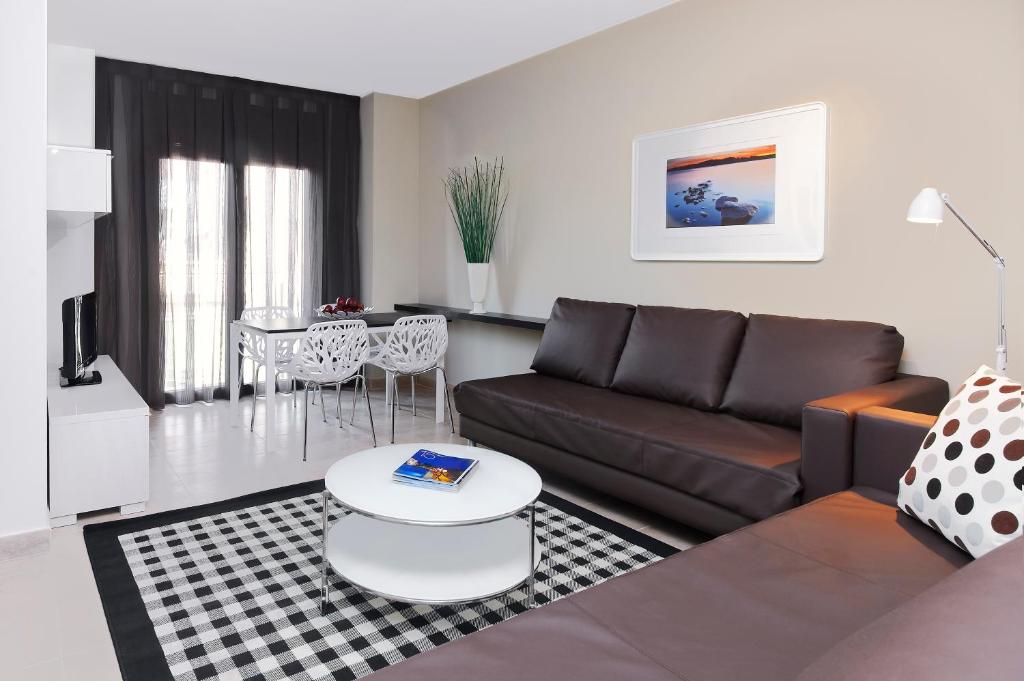 巴塞罗那巴塞罗那格兰德格拉西亚大道公寓酒店的客厅配有沙发和桌子
