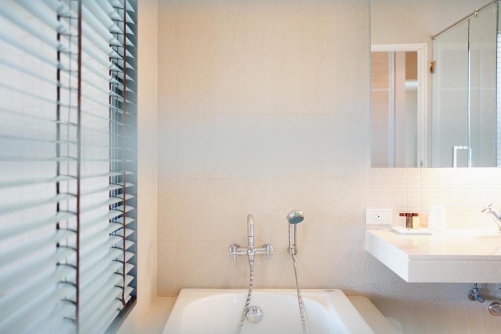 七岩华欣棕榈湾畔酒店的带浴缸和盥洗盆的浴室
