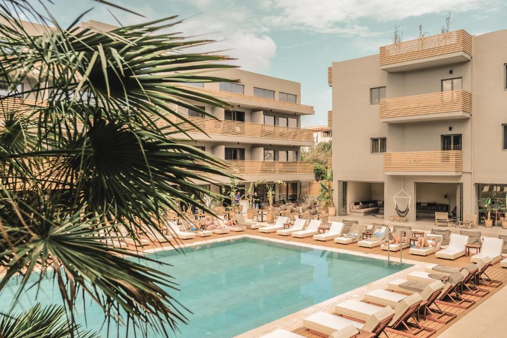 赫索尼索斯Cook's Club Hersonissos Crete的一座游泳池位于酒店前,配有躺椅