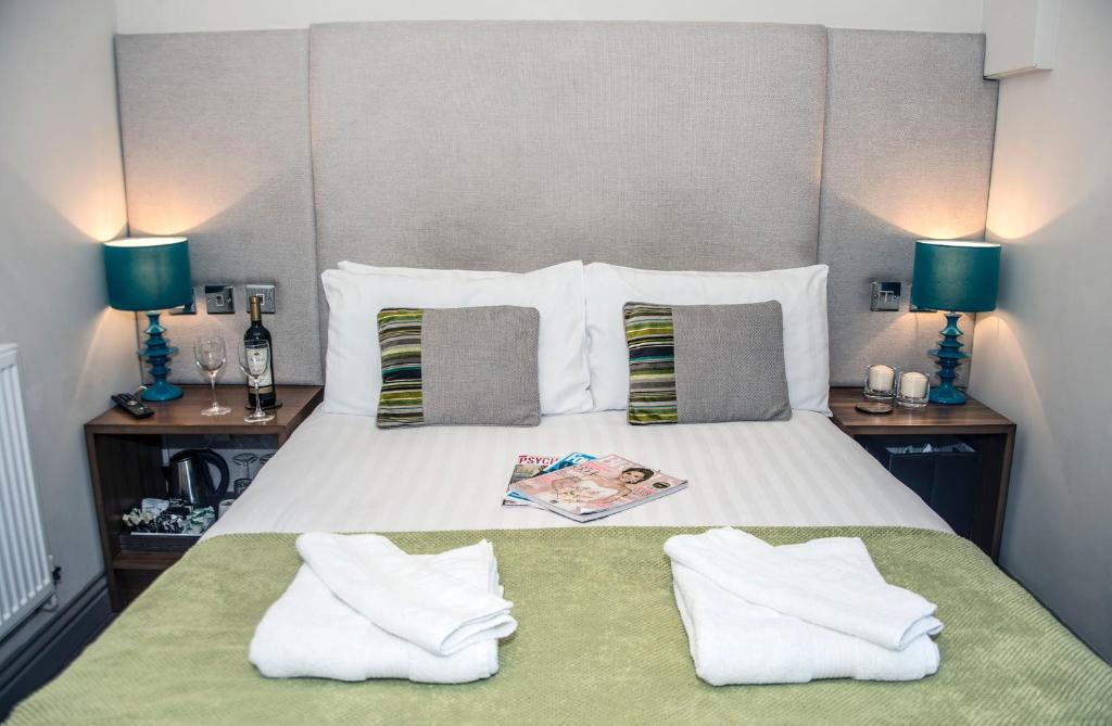 切斯特Book A Base - Chester - City Road的一间卧室配有一张带两个枕头和两个灯的床。