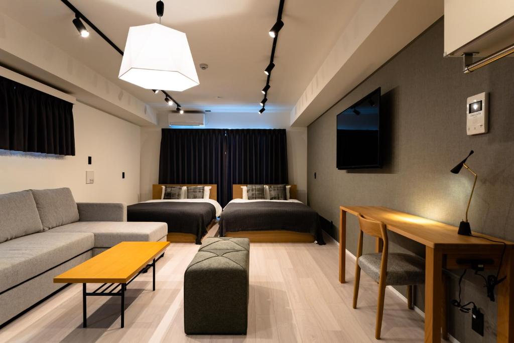 大阪STAY IN YEBISU的客厅配有沙发和桌子