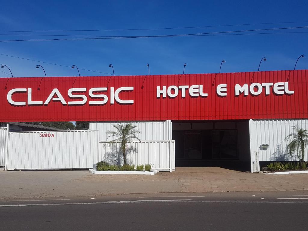 南圣克鲁斯Classic Hotel e Motel的拥有红白色建筑的酒店和汽车旅馆