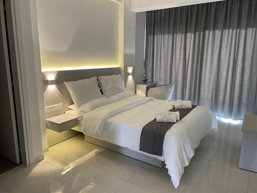 拉纳卡La Veranda Hotel的一间卧室设有一张大床和一个窗户。