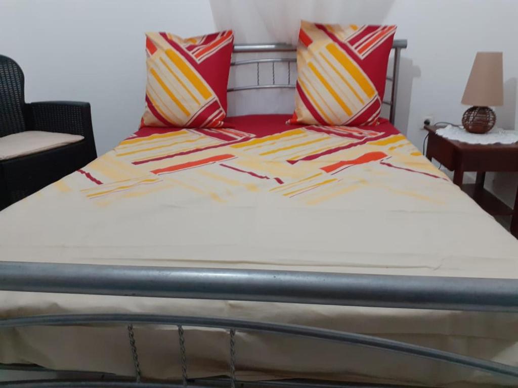圣吕斯Edelweis的一张带红色和黄色毯子及枕头的床