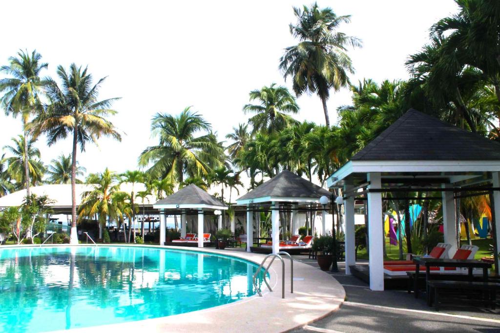 达沃市Waterfront Insular Hotel Davao的一个带凉亭和棕榈树的游泳池