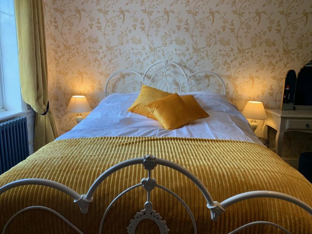 埃克塞特Seven Stars Boutique Guesthouse的一间卧室配有一张黄色枕头的床