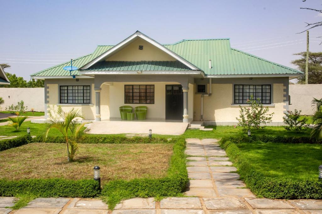洛德瓦尔Lodwar Acacia Residences的白色的房屋,设有绿色的屋顶