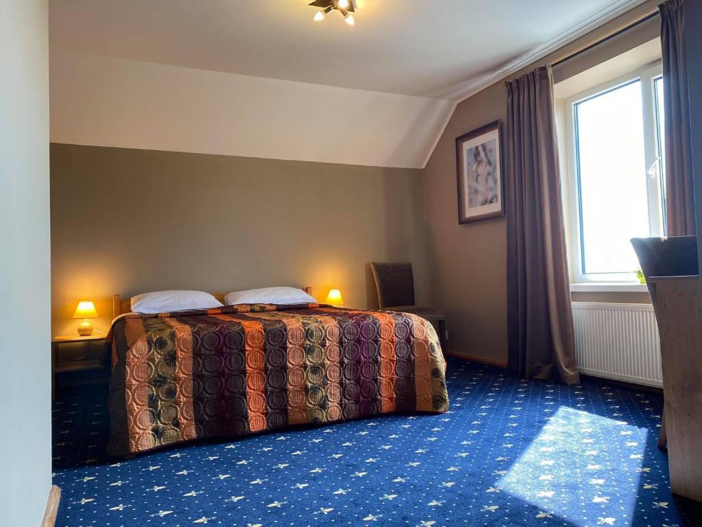 希奥利艾Šeduvos malūnas的酒店客房设有床和窗户。