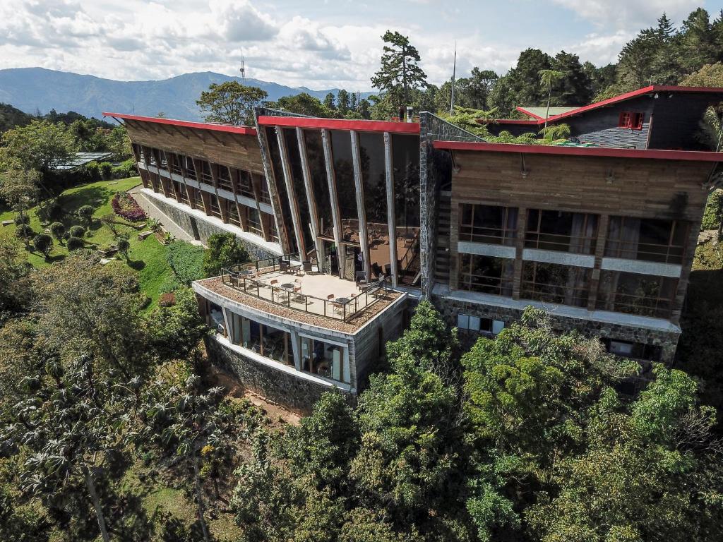 瓜尔内Hotel Piedras Blancas - Comfenalco Antioquia的树木中建筑物的空中景观