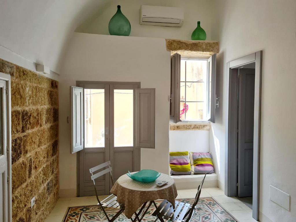 马蒂诺La casa dei Bombi - Polline (casa da 2)的客房设有桌椅和2扇窗户。