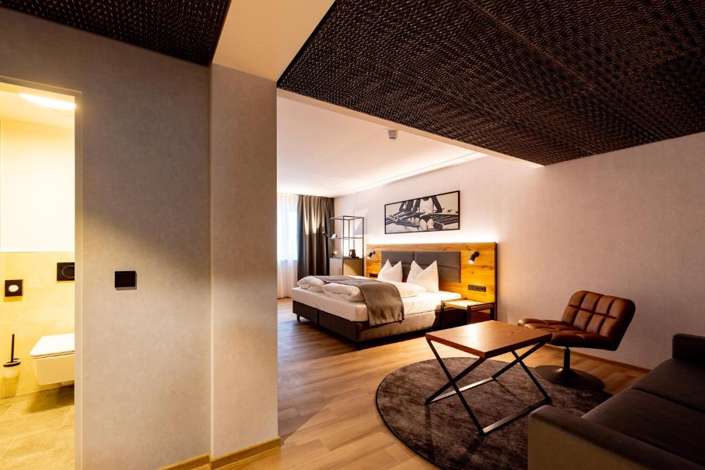帕绍mk hotel passau的一间卧室设有一张床和一间客厅。