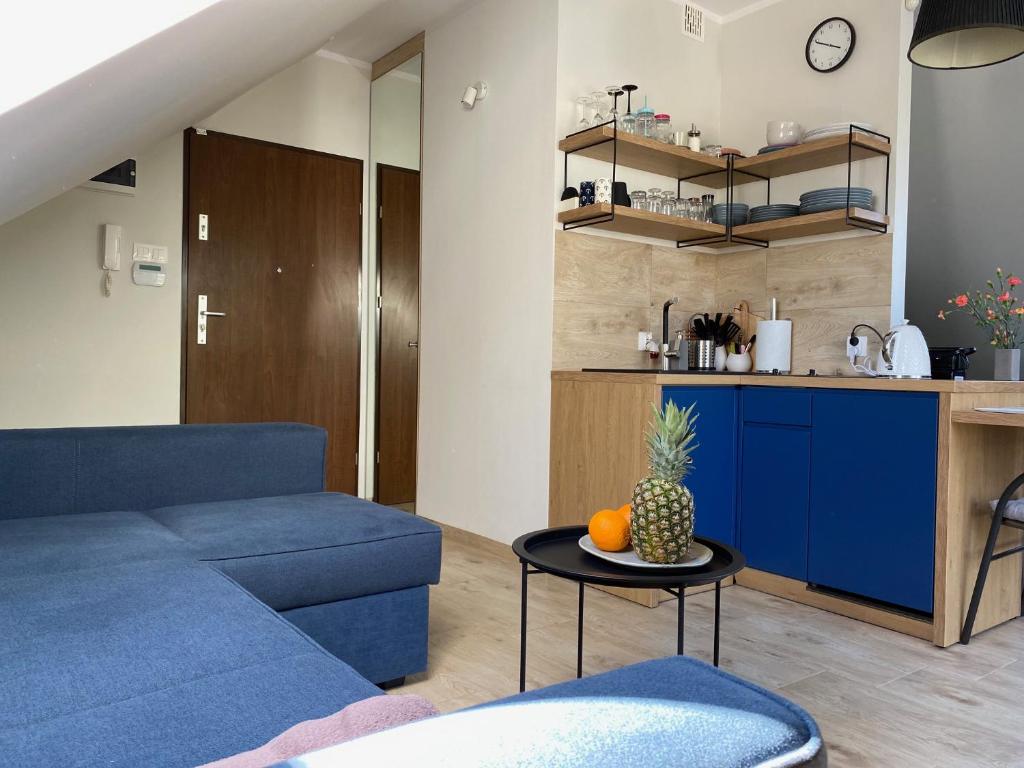 德布吉Apartament w Dębkach的客厅配有蓝色的沙发和桌子