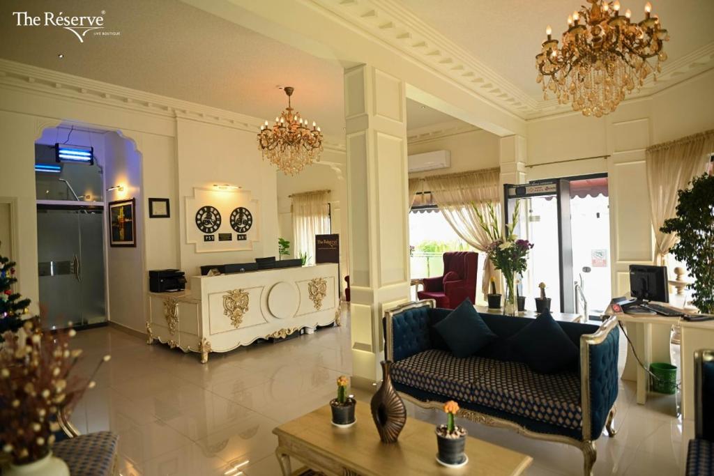 卡拉奇The Reserve Boutique Hotel的客厅配有沙发和桌子
