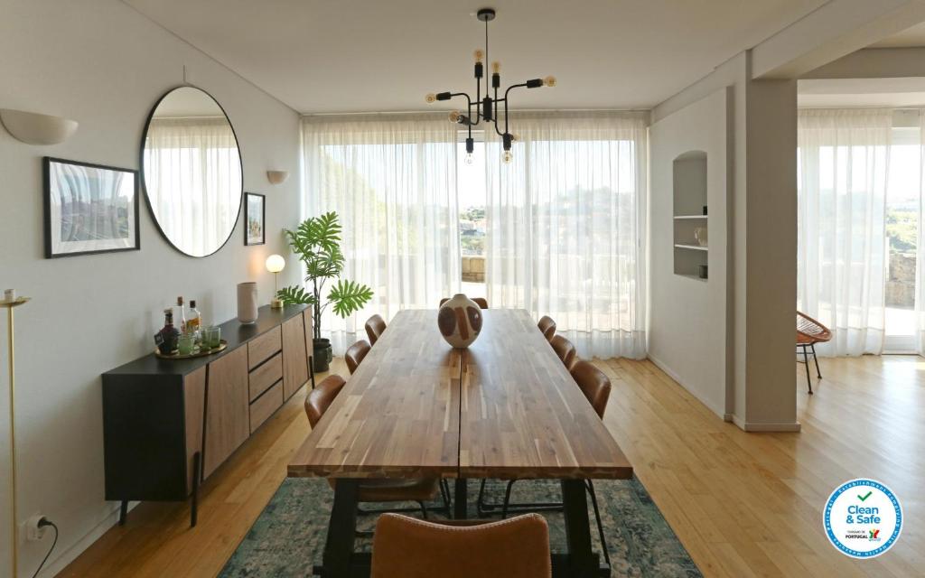 波尔图Villa D'Ouro的一间带木桌和椅子的用餐室