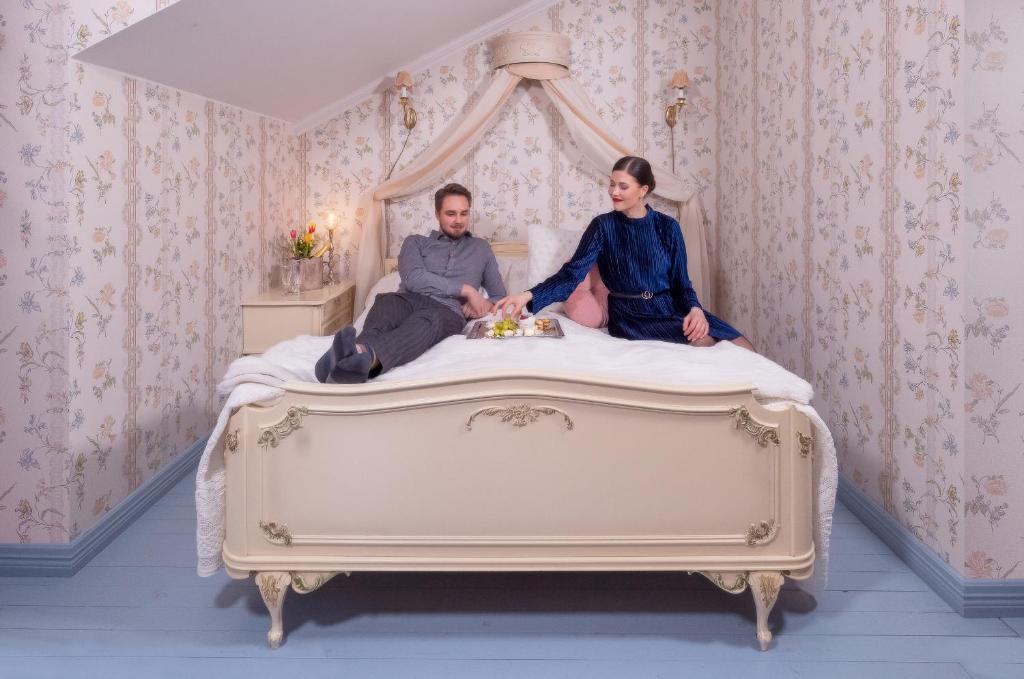 Kankainen塔轮卡诺酒店的坐在床上的男人和女人