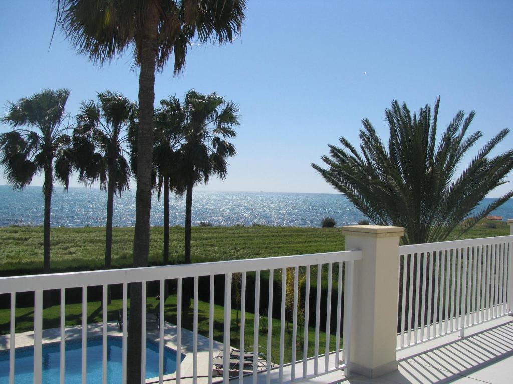 帕福斯秘密花园别墅的阳台享有大海和棕榈树的景致。