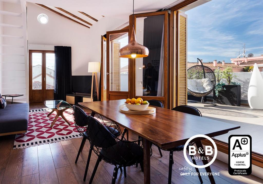 马德里马德里市中心弗恩卡拉尔46号住宿加早餐公寓的一间带木桌和椅子的用餐室