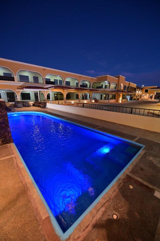 托雷翁Hotel San Ignacio Inn的一座游泳池,在晚上在建筑物前