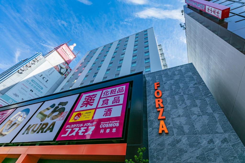 大阪Hotel Forza Osaka Namba的前面有标志的高楼