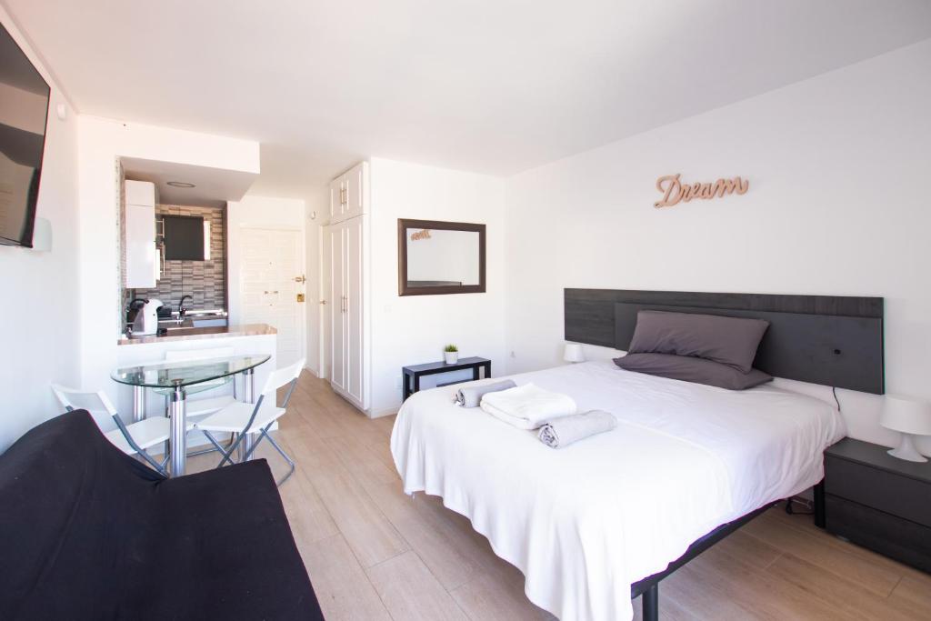 贝纳尔马德纳Dream Studio in Benalmadena Costa del Sol的卧室配有一张白色的大床和一张桌子