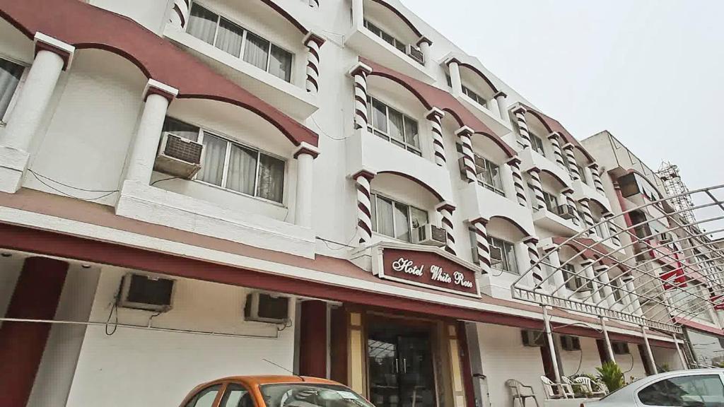 巴夫那加尔Wonderful View Hotel WR Bhavnagar的一座白色的大建筑,上面有标志