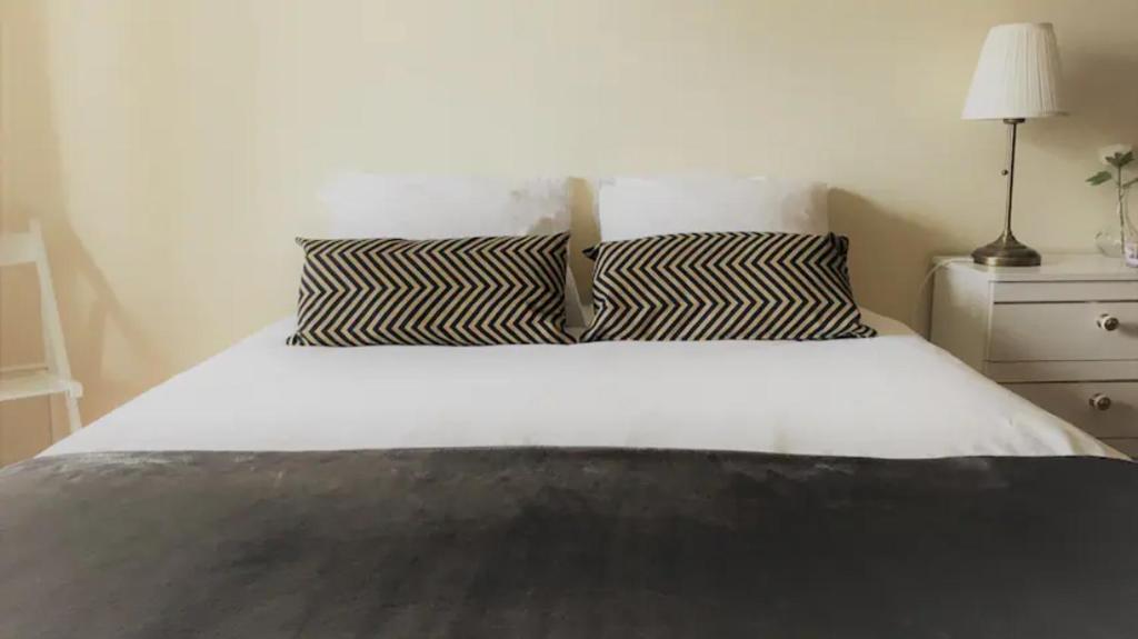 楼尔cosy2bedroomapartment的床上有黑白枕头