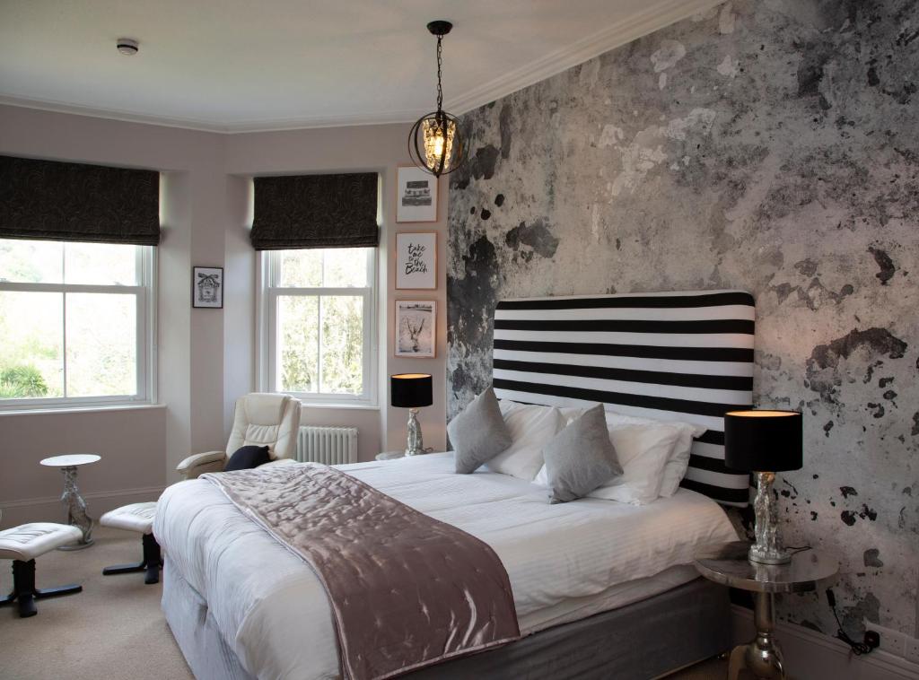托基2012星级金奖酒店的一间卧室配有一张大床,配有黑白床头板