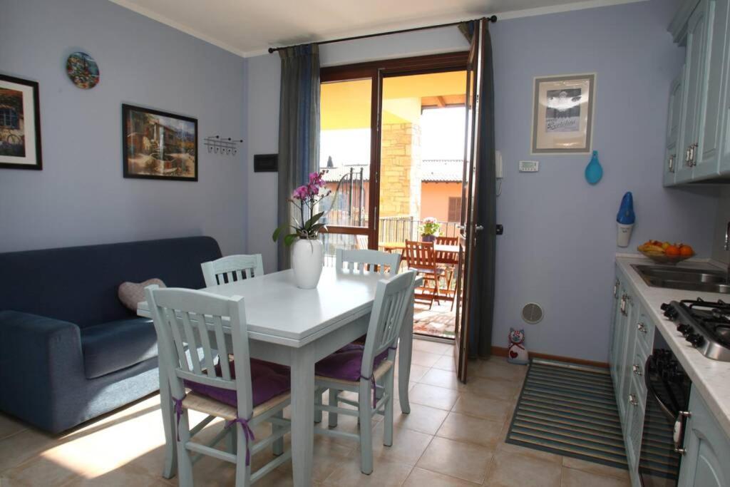 托斯科拉诺-马德尔诺Casa Mirella - Toscolano Maderno的厨房以及带桌椅的用餐室。