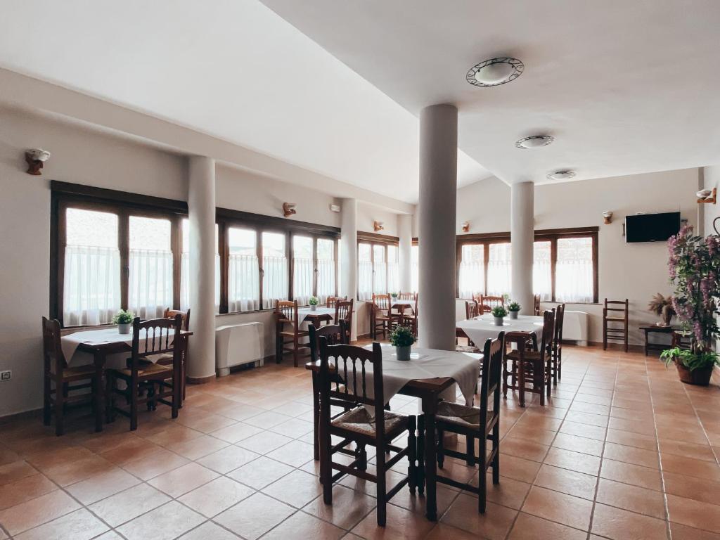 阿尔巴拉辛Hotel Valdevécar的用餐室设有桌椅和窗户。