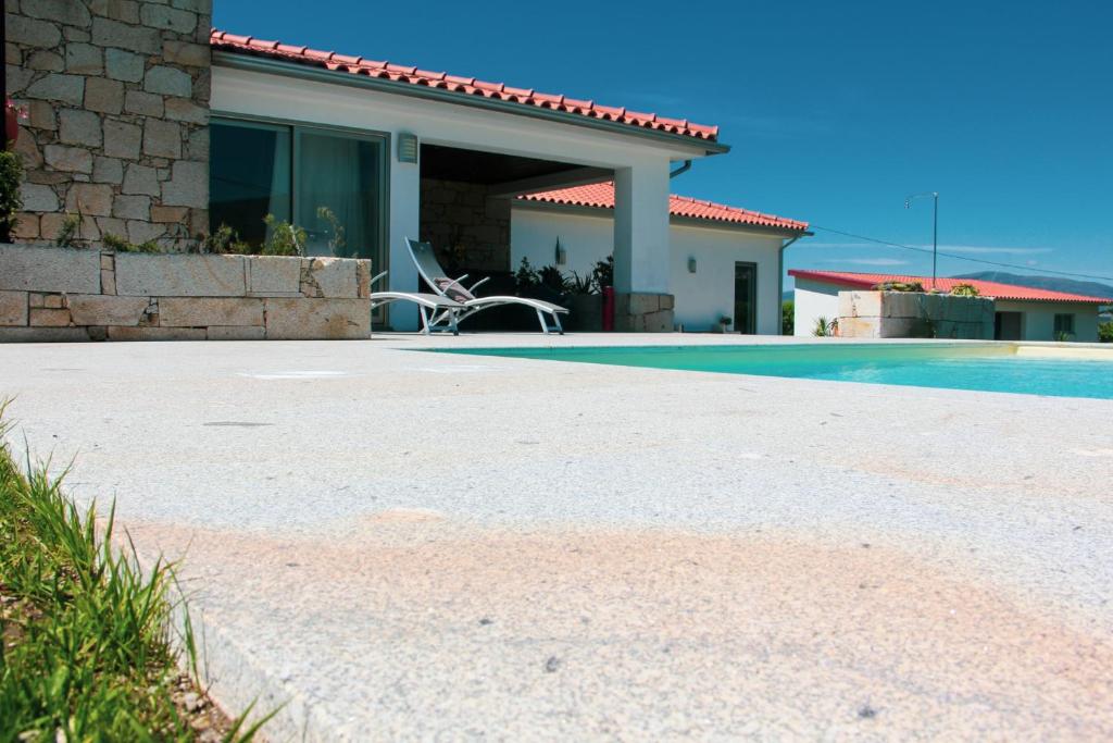 蒙考Casa da Reguenga的一座房子前面设有游泳池