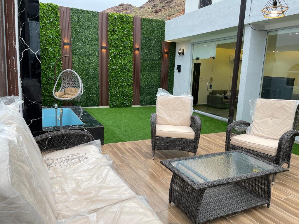 塔伊夫Luxury OVO Roof Villa的天井配有沙发、椅子和树 ⁇ 