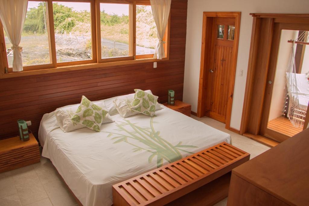 比亚米尔港切斯马纳加拉帕戈斯生态度假酒店的一间卧室配有一张带白色床单的床和一扇窗户。
