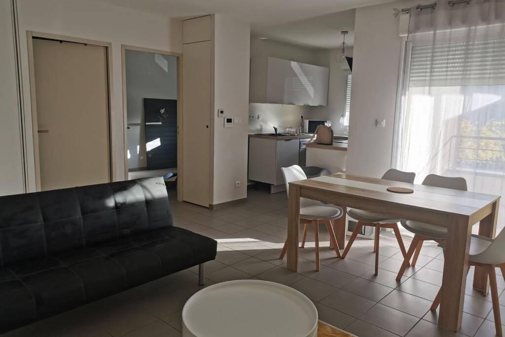 奥内莱沙托Appartement T2 accessible PMR avec terrasse et garage的客厅配有沙发和桌椅
