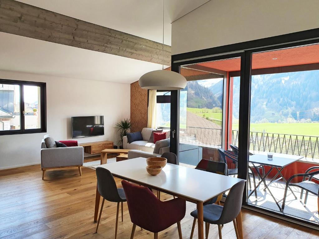迪森蒂斯3,5 Zimmer Dachwohnung: Modern, komfortabel, zentral, mit Bergsicht的客厅配有桌椅