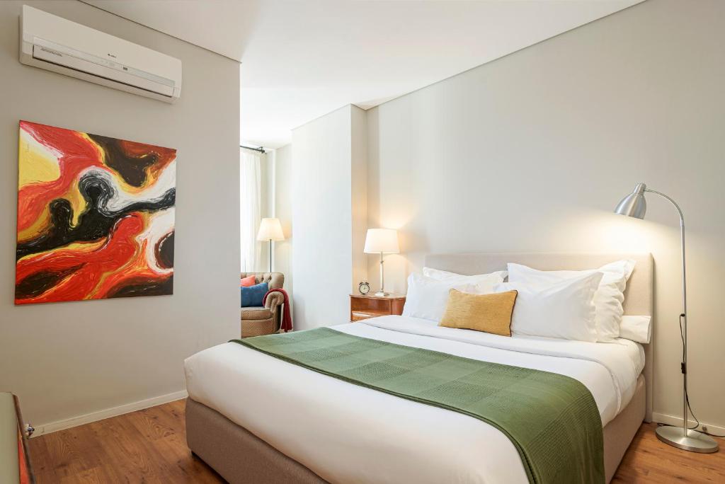 波尔图B闹市区客人酒店的一间卧室配有一张壁画床