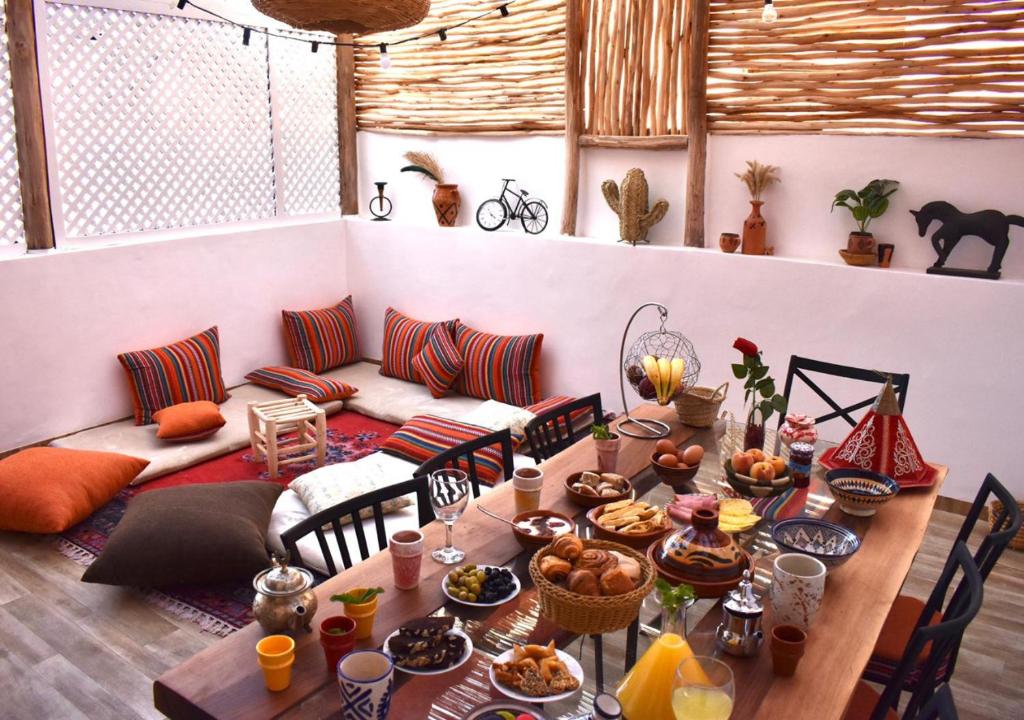 马拉喀什COSY LUXURY Apartment - GUELIZ的一张桌子,桌子上放着食物,沙发上放着