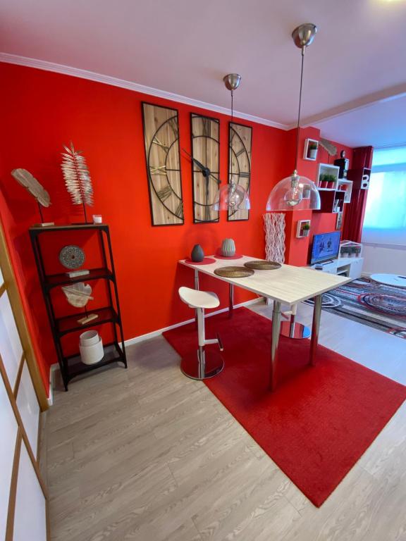 卢戈Apartamento Centro Frente Muralla 2的厨房配有桌子和红色的墙壁