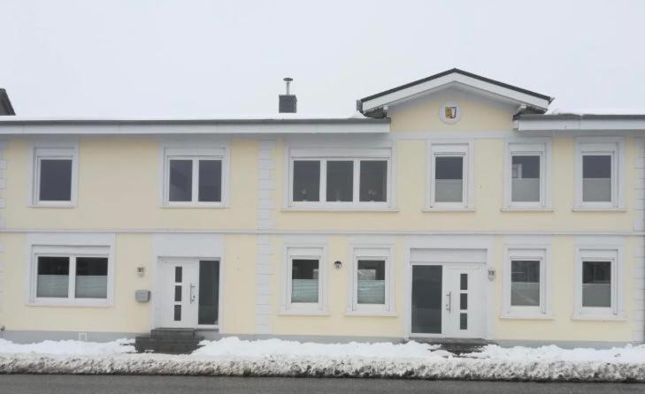 格洛米茨Ferienwohnung Maximilian的前面有雪的大白色房子