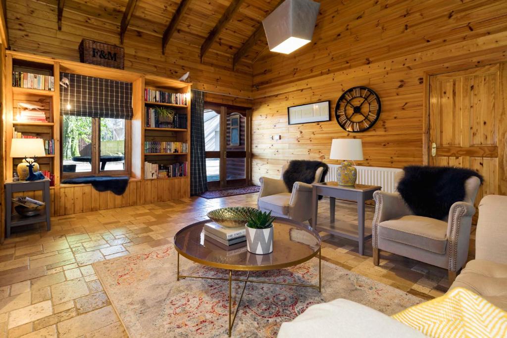 阿马Castledillon Forest Lodge的小屋内带桌椅的客厅